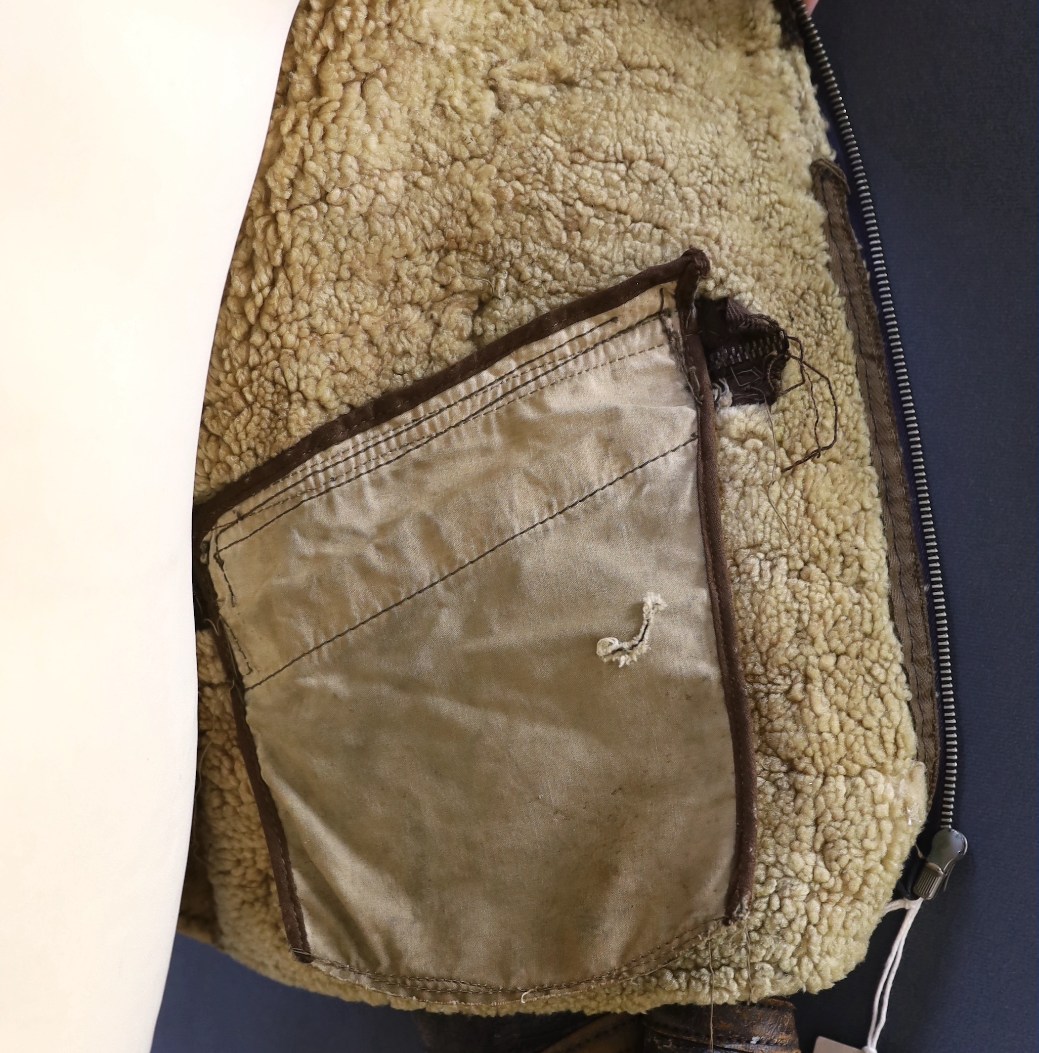 An American US Air Force sheepskin flying jacket, with applied label in collar reading ‘TYPE ….. SIZE MEDIUM SPEC NO. 94-3084 ORDER NO 42-12685-P PROPERTY AIR FORCE U.S. ARMY H. BERNSTEIN & CO.’